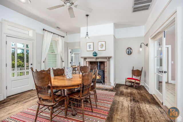 197 N 200 W, Kanab, UT 84741 - dining room featuring visible vents, french doors, a wood stove, wood finished floors, and a ceiling fan