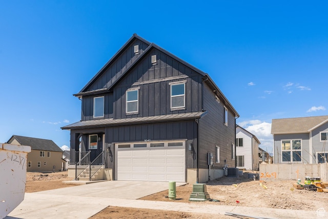 1041 N 3620 W Unit 268, Lehi, UT 84043 - view of front of home featuring board and batten siding, a standing seam roof, concrete driveway, a garage, and central AC