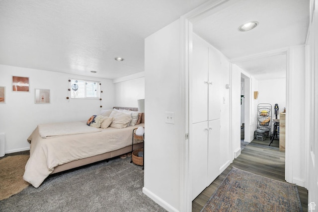 bedroom with baseboards and dark wood-style floors