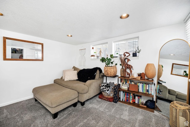 carpeted living area with recessed lighting and baseboards