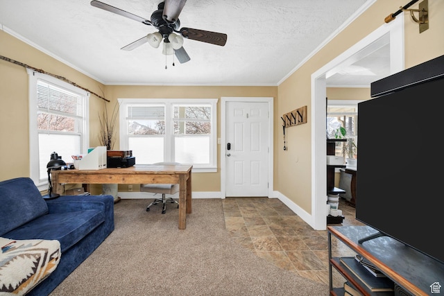 carpeted home office featuring a textured ceiling, baseboards, ceiling fan, and ornamental molding