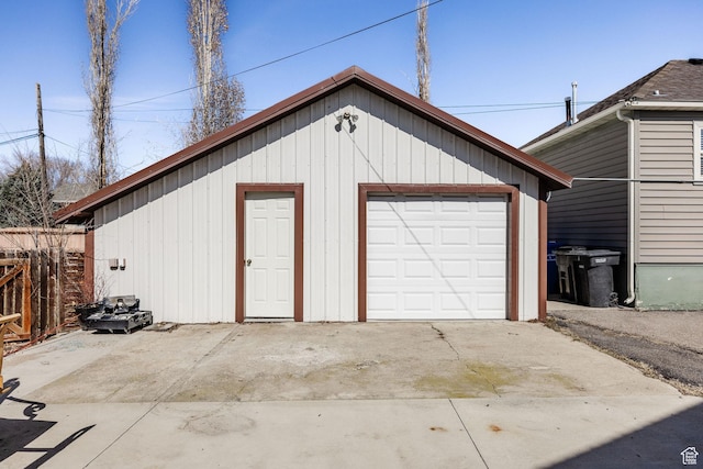 detached garage with driveway and fence