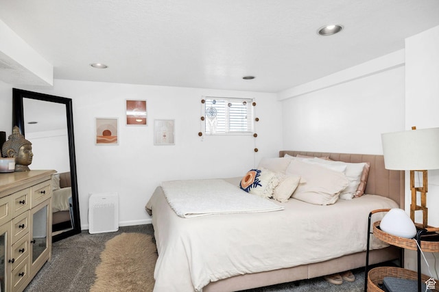 bedroom featuring recessed lighting, baseboards, and dark colored carpet