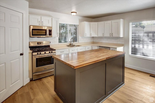 5772 Oakwood Dr, South Ogden, UT 84405 - kitchen featuring stainless steel appliances, wooden counters, white cabinets, and tasteful backsplash