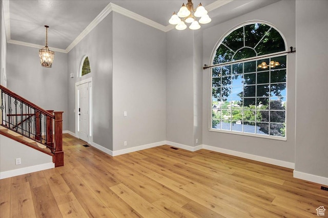 5772 Oakwood Dr, South Ogden, UT 84405 - foyer featuring a chandelier, stairway, light wood-style floors, and crown molding