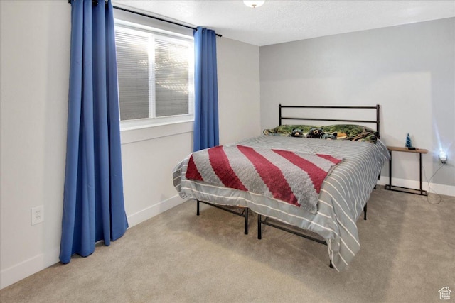 bedroom with baseboards, carpet floors, and a textured ceiling