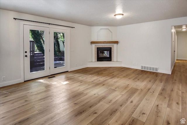 5772 Oakwood Dr, South Ogden, UT 84405 - unfurnished living room with light wood-style floors and a glass covered fireplace