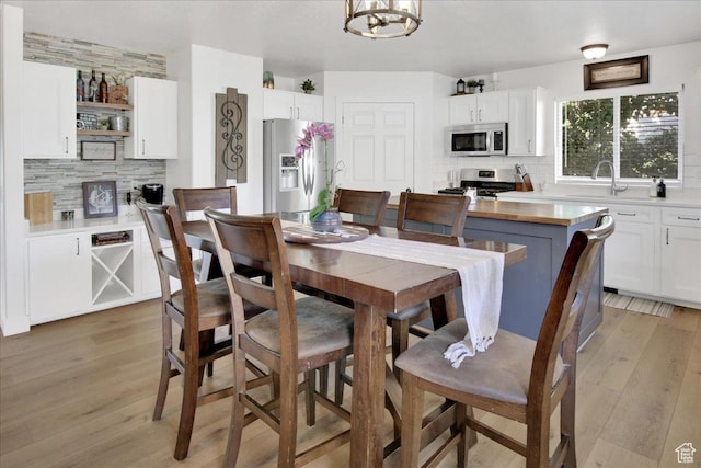 dining room with an inviting chandelier and light wood-style flooring