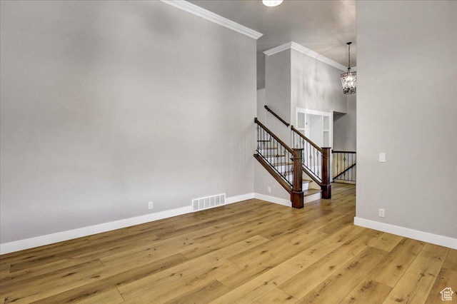5772 Oakwood Dr, South Ogden, UT 84405 - unfurnished living room featuring ornamental molding, hardwood / wood-style floors, a chandelier, and stairway