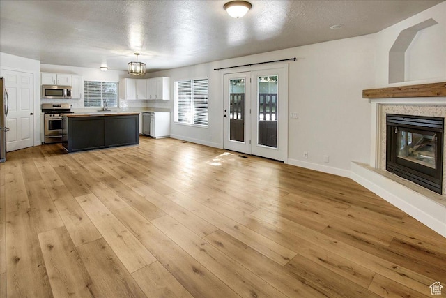 5772 Oakwood Dr, South Ogden, UT 84405 - kitchen with stainless steel appliances, white cabinetry, healthy amount of natural light, and a center island