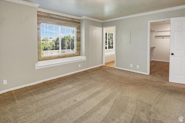 5772 Oakwood Dr, South Ogden, UT 84405 - unfurnished bedroom with ornamental molding, carpet floors, a spacious closet, and a closet