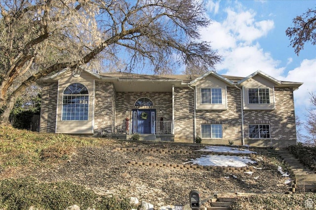 raised ranch featuring brick siding