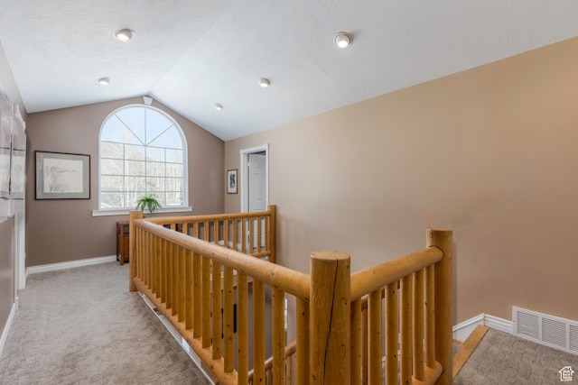 161 W Swiss Farm Way Unit 9, Midway, UT 84049 - hallway featuring visible vents, baseboards, vaulted ceiling, an upstairs landing, and light carpet