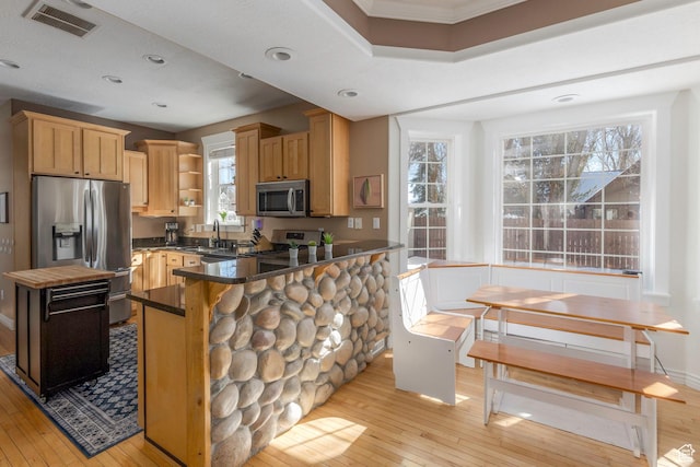 161 W Swiss Farm Way Unit 9, Midway, UT 84049 - kitchen with dark countertops, visible vents, appliances with stainless steel finishes, light wood-style floors, and open shelves