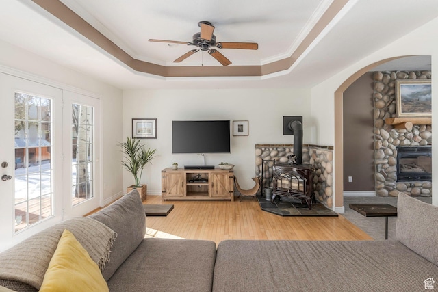 161 W Swiss Farm Way Unit 9, Midway, UT 84049 - living room with crown molding, light wood-type flooring, a wood stove, a raised ceiling, and a ceiling fan