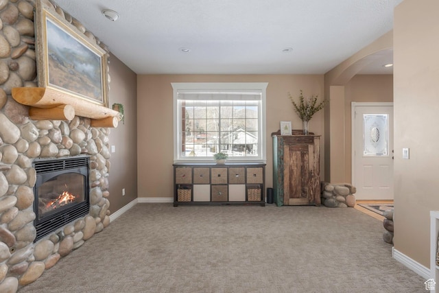 161 W Swiss Farm Way Unit 9, Midway, UT 84049 - carpeted living room featuring baseboards, arched walkways, and a fireplace