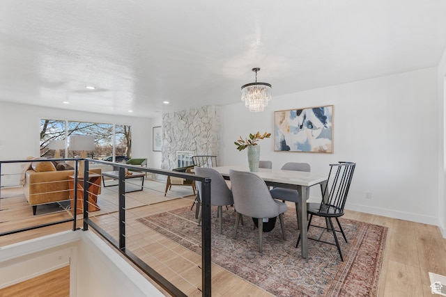 4375 S 2700 E, Holladay, UT 84124 - dining space with light wood finished floors, baseboards, a chandelier, recessed lighting, and a textured ceiling