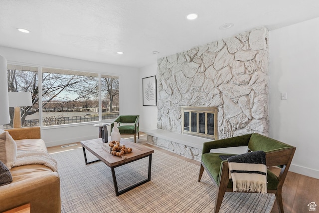 4375 S 2700 E, Holladay, UT 84124 - living room featuring visible vents, baseboards, recessed lighting, a fireplace, and wood finished floors