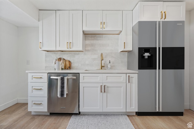 4375 S 2700 E, Holladay, UT 84124 - kitchen with decorative backsplash, appliances with stainless steel finishes, white cabinets, and light wood finished floors