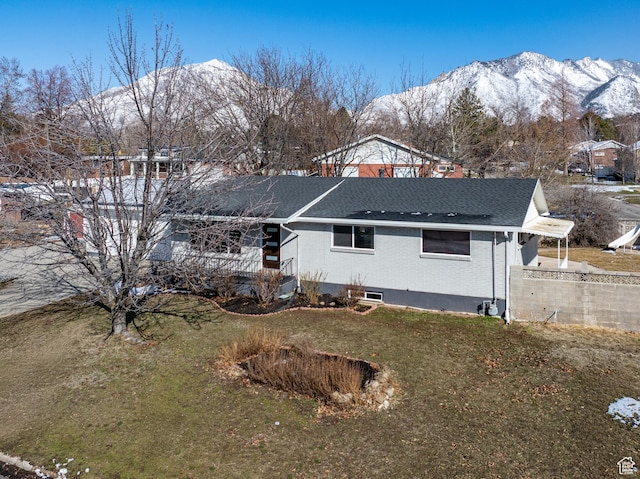 4375 S 2700 E, Holladay, UT 84124 - rear view of property with a mountain view, brick siding, roof with shingles, and a yard