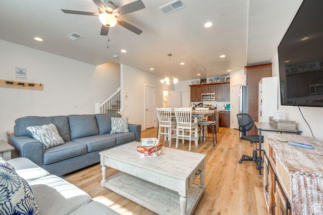 498 W 1225 N Unit 28, Cedar City, UT 84721 - living room featuring ceiling fan with notable chandelier, stairway, light wood-style flooring, and visible vents