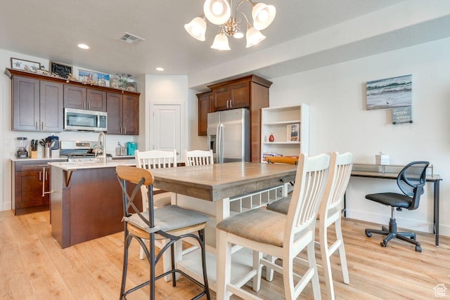 498 W 1225 N Unit 28, Cedar City, UT 84721 - kitchen with visible vents, appliances with stainless steel finishes, light wood-style flooring, and light countertops