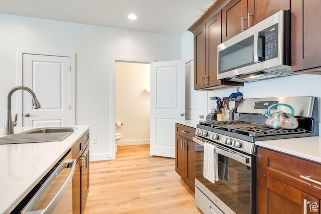 498 W 1225 N Unit 28, Cedar City, UT 84721 - kitchen with a sink, appliances with stainless steel finishes, light wood finished floors, baseboards, and light countertops