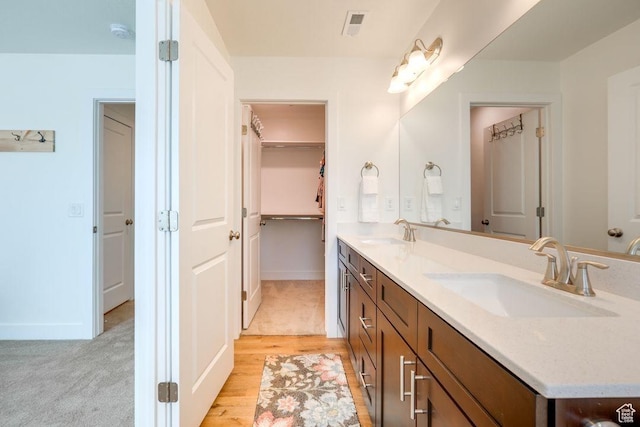 498 W 1225 N Unit 28, Cedar City, UT 84721 - bathroom featuring double vanity, visible vents, wood finished floors, and a sink