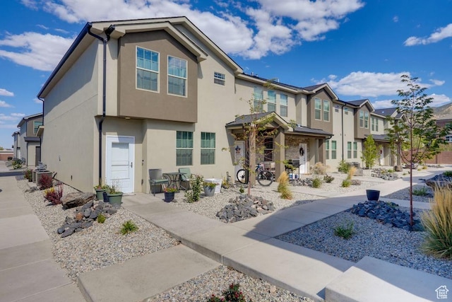view of front of house with a residential view and stucco siding