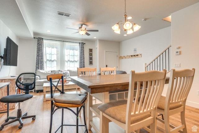498 W 1225 N Unit 28, Cedar City, UT 84721 - dining room featuring light wood-type flooring, visible vents, ceiling fan with notable chandelier, baseboards, and stairs