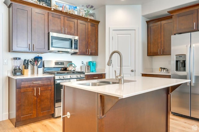 498 W 1225 N Unit 28, Cedar City, UT 84721 - kitchen featuring an island with sink, light countertops, light wood-style flooring, appliances with stainless steel finishes, and a sink