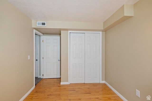 5964 W Jackling Way, West Jordan, UT 84081 - unfurnished bedroom with baseboards, visible vents, a closet, and light wood-type flooring