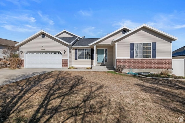 single story home with an attached garage, brick siding, and driveway