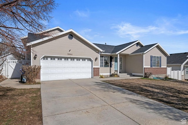 5964 W Jackling Way, West Jordan, UT 84081 - ranch-style house with an attached garage, fence, brick siding, and driveway