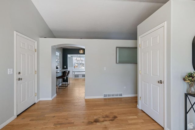 5964 W Jackling Way, West Jordan, UT 84081 - hall with light wood-style floors, visible vents, arched walkways, and baseboards