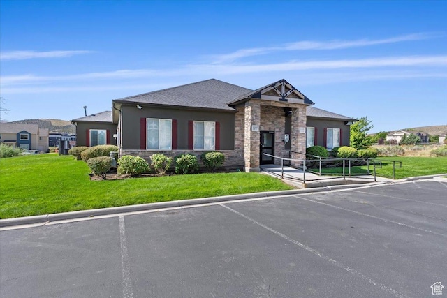 3635 E Clear Rock Rd Unit 4, Eagle Mountain, UT 84005 - view of front of home featuring a front yard, uncovered parking, stone siding, and stucco siding
