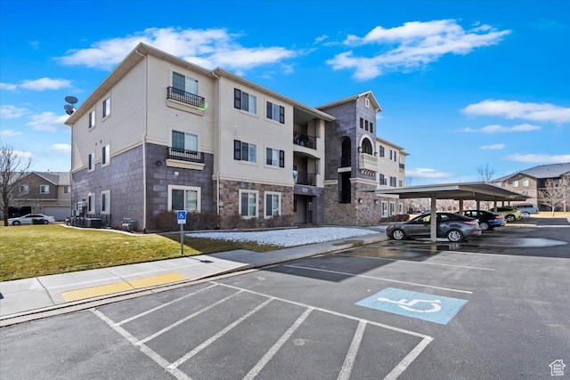 3635 E Clear Rock Rd Unit 4, Eagle Mountain, UT 84005 - view of building exterior with covered and uncovered parking