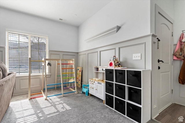 3635 E Clear Rock Rd Unit 4, Eagle Mountain, UT 84005 - recreation room with a decorative wall, wainscoting, carpet flooring, and visible vents