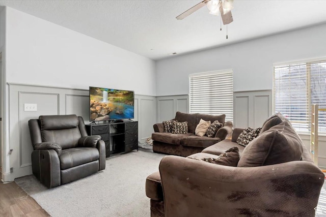 3635 E Clear Rock Rd Unit 4, Eagle Mountain, UT 84005 - living room featuring a decorative wall, light wood-style flooring, wainscoting, and ceiling fan