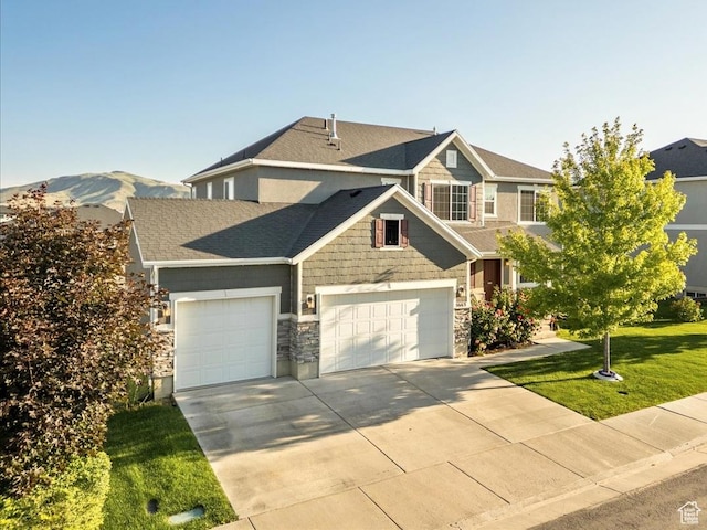 5663 W Yukon Park Ln S, Herriman, UT 84096 - craftsman inspired home with an attached garage, driveway, stone siding, a front lawn, and roof with shingles