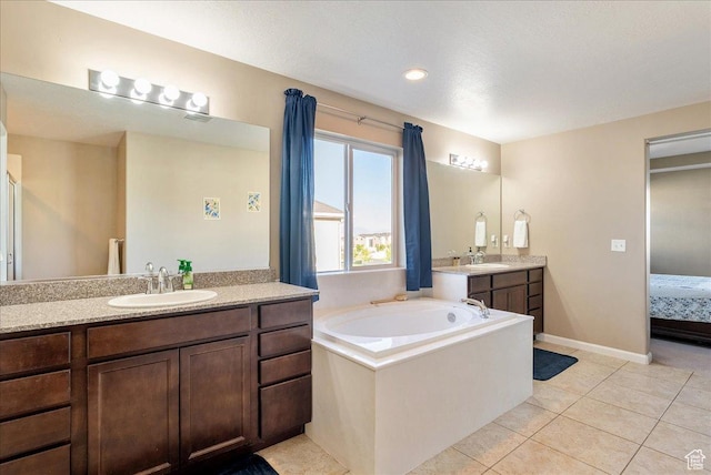 5663 W Yukon Park Ln S, Herriman, UT 84096 - ensuite bathroom featuring two vanities, a bath, tile patterned floors, and baseboards