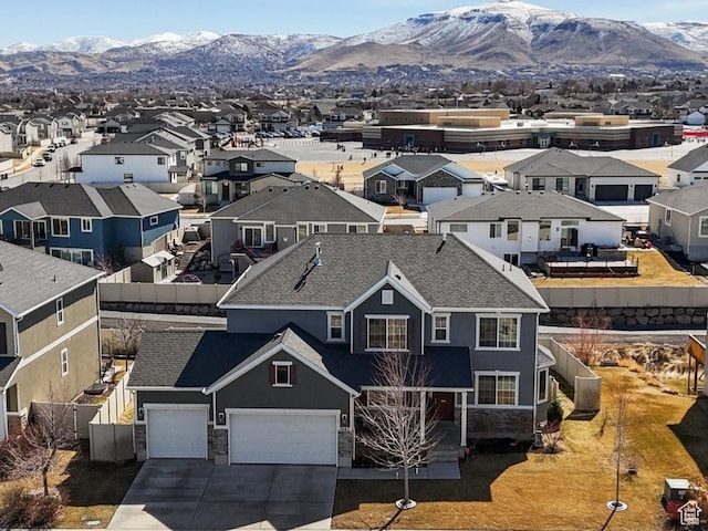 drone / aerial view featuring a residential view and a mountain view