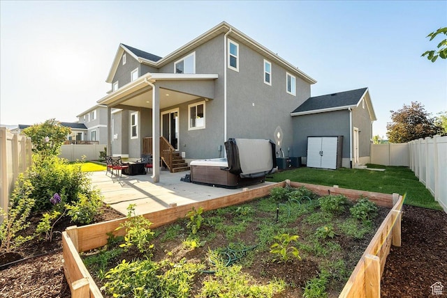 5663 W Yukon Park Ln S, Herriman, UT 84096 - back of house featuring a vegetable garden, a patio, a fenced backyard, and stucco siding
