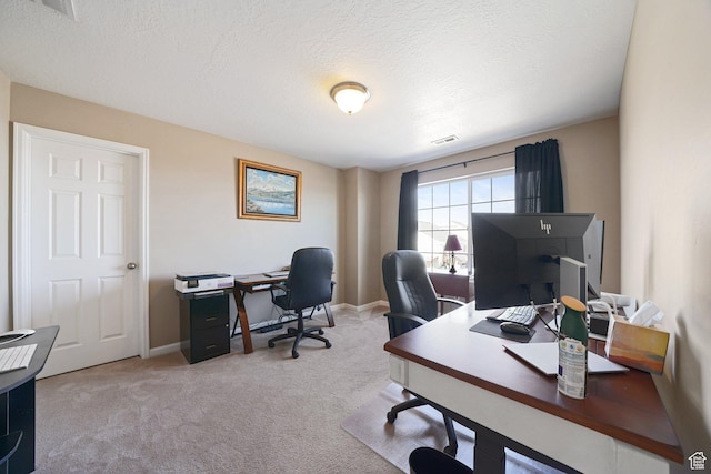 carpeted office space with visible vents, baseboards, and a textured ceiling