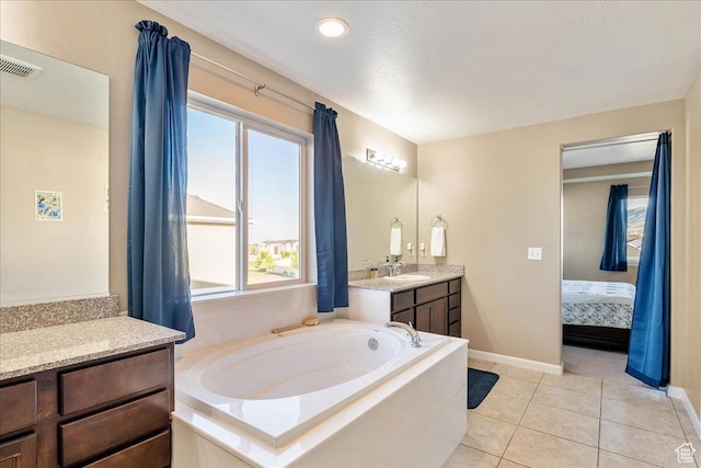 5663 W Yukon Park Ln S, Herriman, UT 84096 - ensuite bathroom featuring vanity, a bath, baseboards, and tile patterned flooring