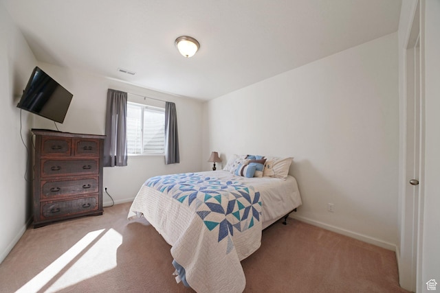 bedroom with light carpet, visible vents, and baseboards