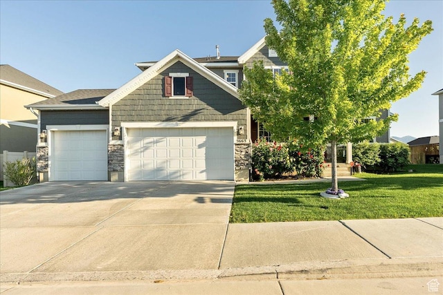 5663 W Yukon Park Ln S, Herriman, UT 84096 - view of front facade featuring an attached garage, concrete driveway, stone siding, and a front yard