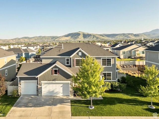 5663 W Yukon Park Ln S, Herriman, UT 84096 - view of front of house featuring a residential view, concrete driveway, a mountain view, and a front yard