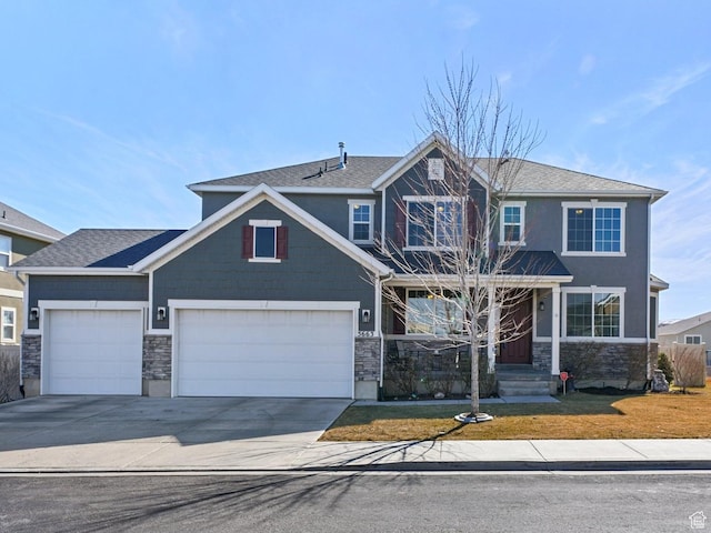 view of front of home featuring an attached garage, driveway, stone siding, and a front lawn