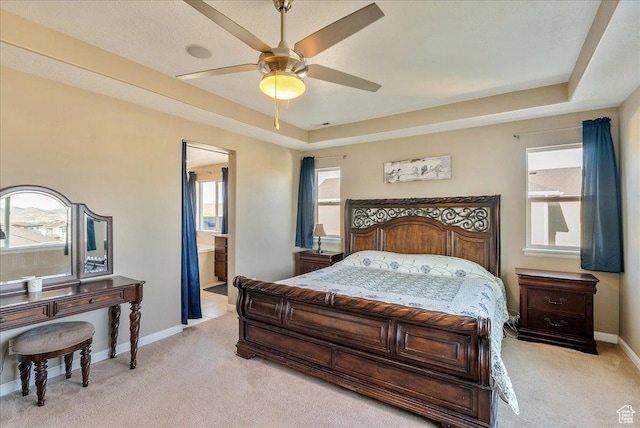 5663 W Yukon Park Ln S, Herriman, UT 84096 - bedroom with light colored carpet, baseboards, a raised ceiling, and connected bathroom